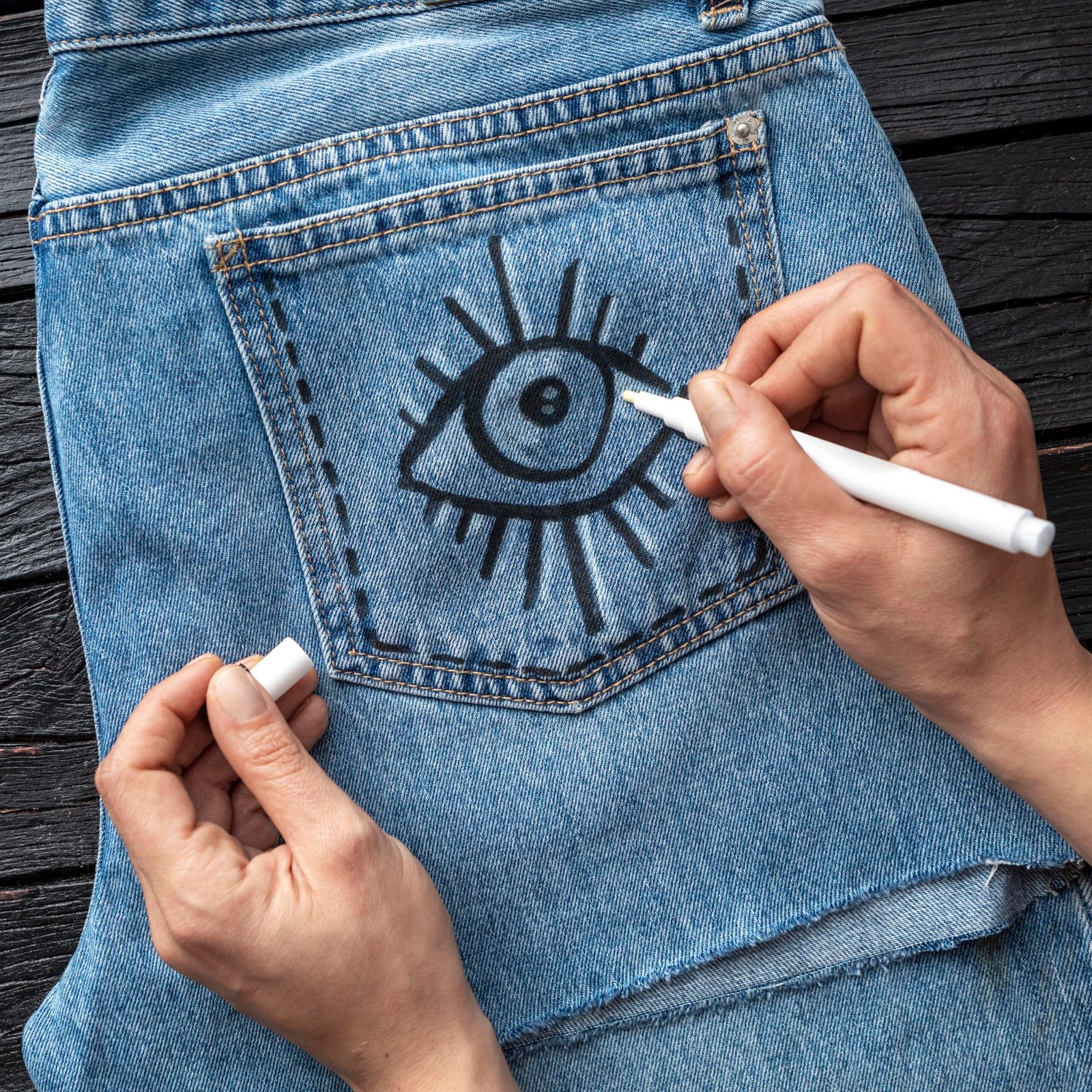 close-up-hand-drawing-jeans